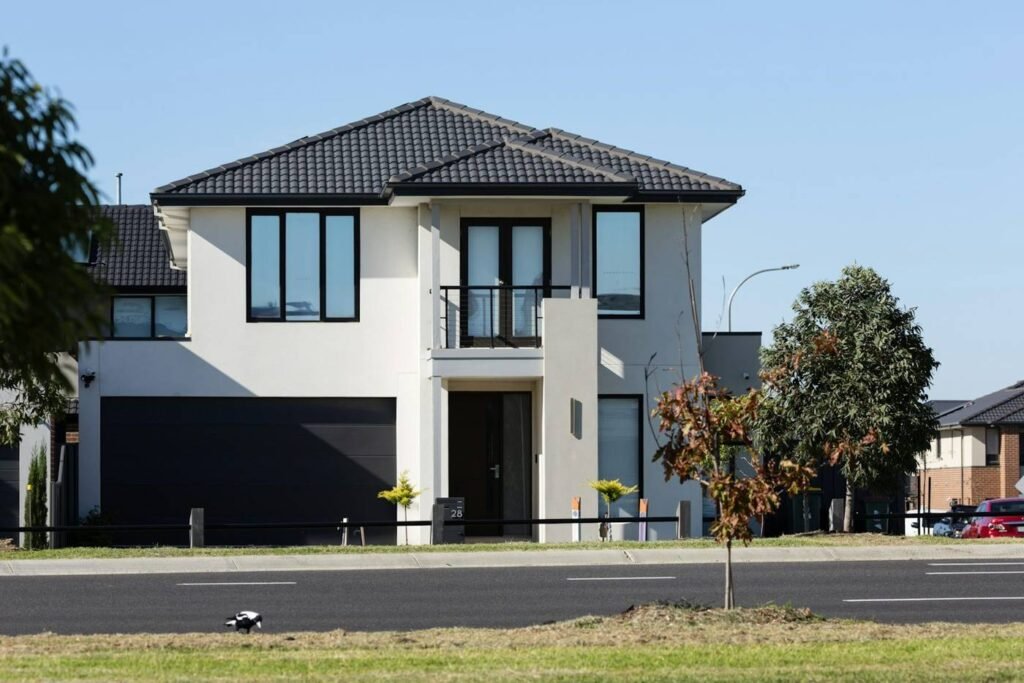 Modern two-story single-family home with dark garage door in an Eastside neighborhood