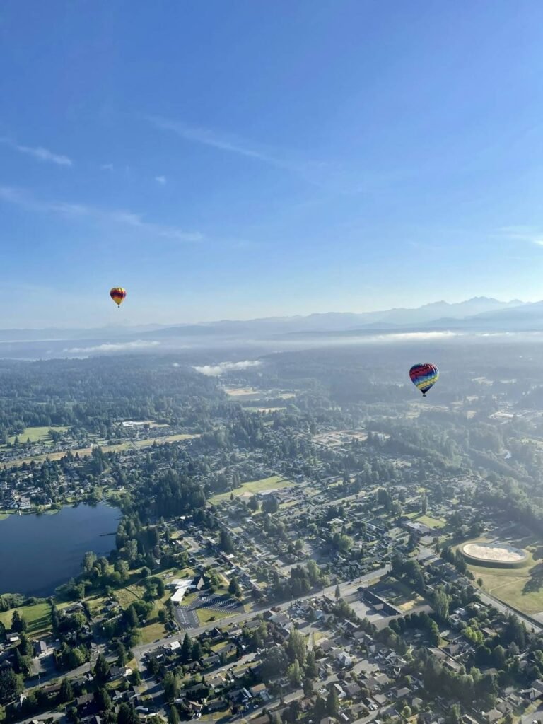 Hot air balloons floating above the Snohomish valley at sunrise