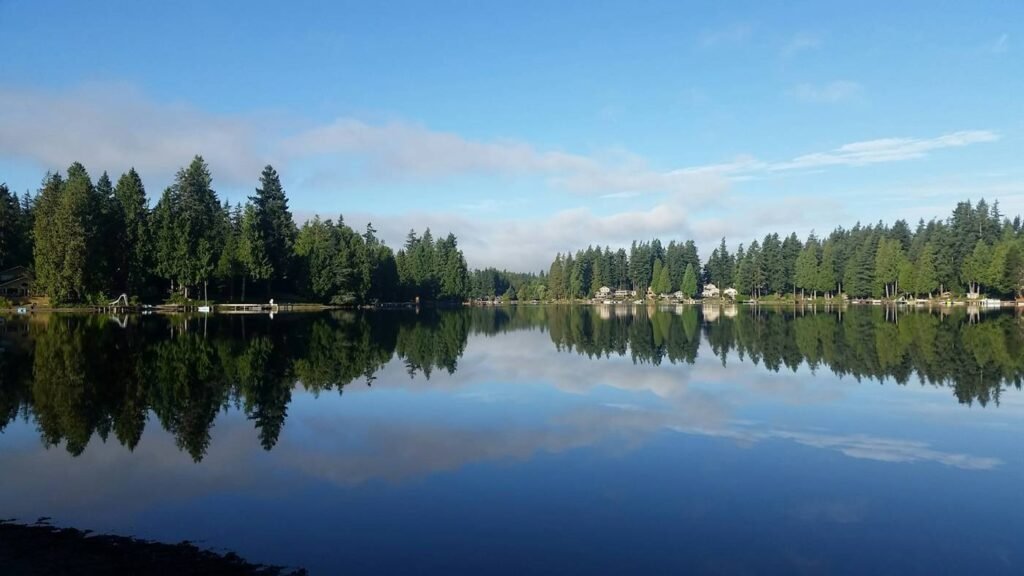 Calm lake reflecting evergreen trees on the Sammamish plateau