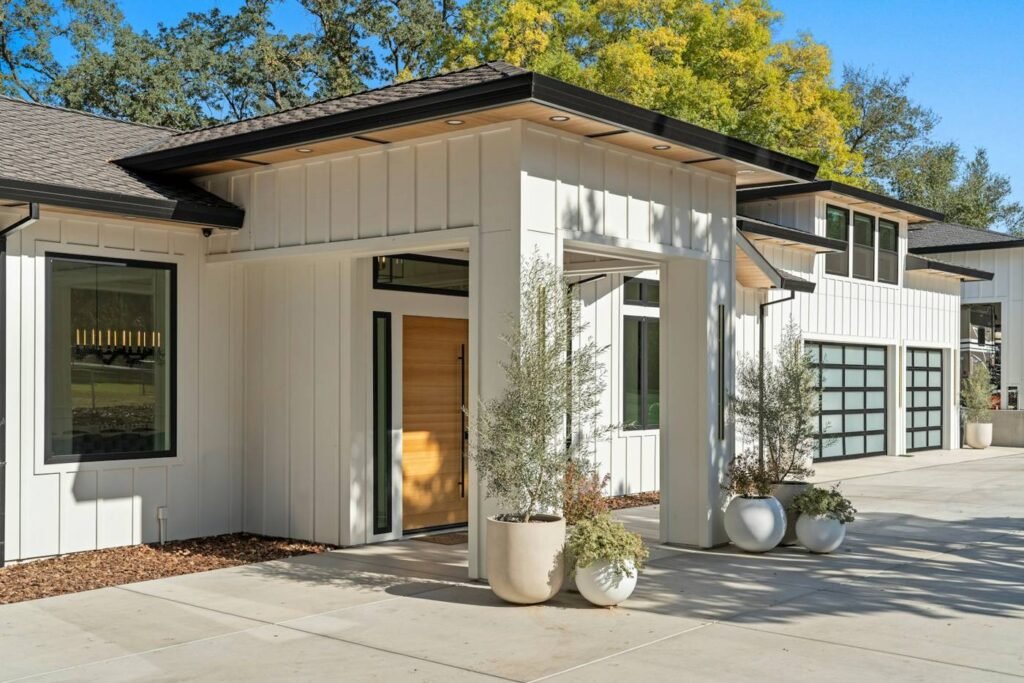 Modern new-construction home with white board-and-batten siding and large windows